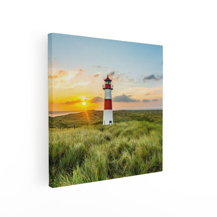 Canvas schilderij vierkant Vuurtoren met Zonsopgang op een Eiland
