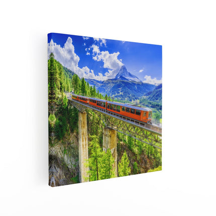 Canvas schilderij vierkant Trein op een Brug bij een Waterval in Zwitserland