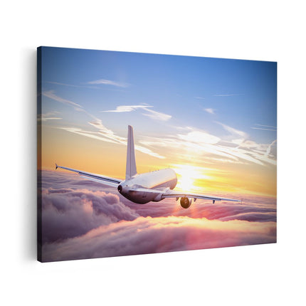 Canvas schilderij vooraanzicht Vliegtuig In De Wolken Bij Zonsondergang