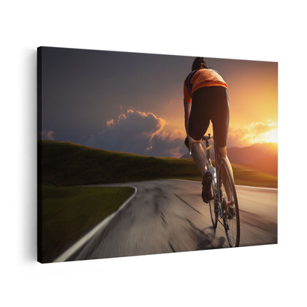 Canvas schilderij vooraanzicht Wielrennen Fietser op de Weg bij Zonsondergang