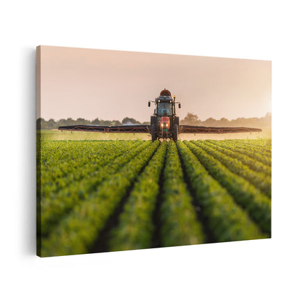 Canvas schilderij vooraanzicht Rode Tractor op het Veld aan het Sproeien