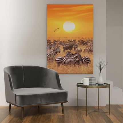 Canvas schilderij interieur Kudde Zebra's Bij Een Oranje Zonsondergang