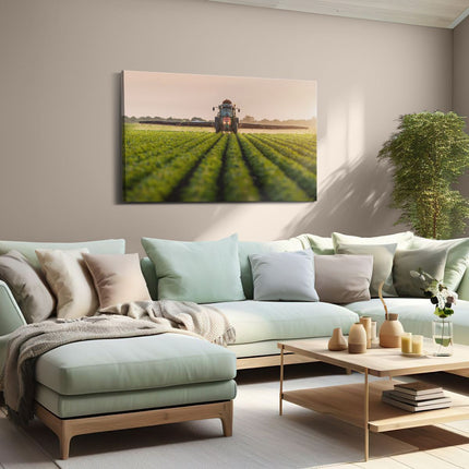 Canvas schilderij woonkamer Rode Tractor op het Veld aan het Sproeien