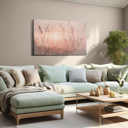 Canvas schilderij woonkamer De Zon gaat onder boven een Grasveld