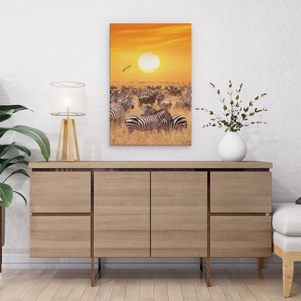 Canvas schilderij interieur Kudde Zebra's Bij Een Oranje Zonsondergang