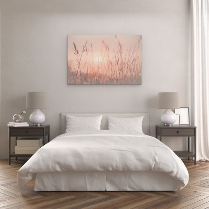 Canvas schilderij slaapkamer De Zon gaat onder boven een Grasveld