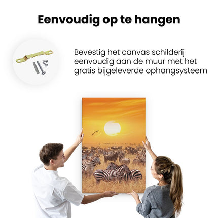 Canvas schilderij ophangen Kudde Zebra's Bij Een Oranje Zonsondergang