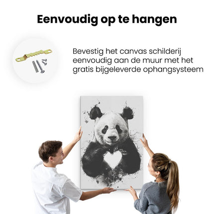 Canvas schilderij ophangen Pandabeer die een Hart Vasthoudt