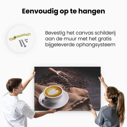 Canvas schilderij ophangen Kopje Koffie In Een Hartje Met Koffiebonen
