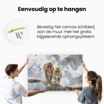 Canvas schilderij ophangen Twee Aapjes In De Sneeuw Op Rotsen
