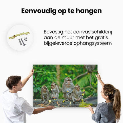 Canvas schilderij ophangen Groep Apen Eten Bananen In Het Bos