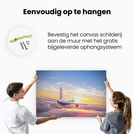 Canvas schilderij ophangen Vliegtuig In De Wolken Bij Zonsondergang