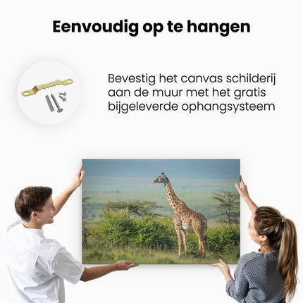 Canvas schilderij ophangen Giraffe In Het Wild Tussen De Struiken