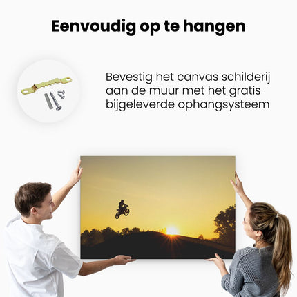 Canvas schilderij ophangen Silhouet Van Een Motorcross Bij Zonsondergang