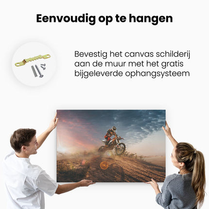 Canvas schilderij ophangen Motorcross Op Een Heuvel Bij Zonsondergang