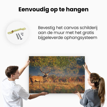 Canvas schilderij ophangen Hert onder een Boom in de Weide