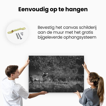 Canvas schilderij ophangen Hert onder een Boom in de Weide - Zwart Wit