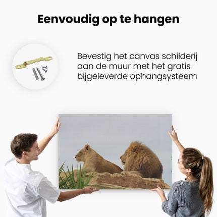 Canvas schilderij ophangen Leeuw en Leeuwin op een Rots