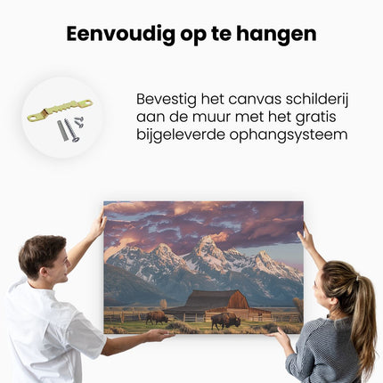 Canvas schilderij ophangen Bizons Grazen voor een Schuur