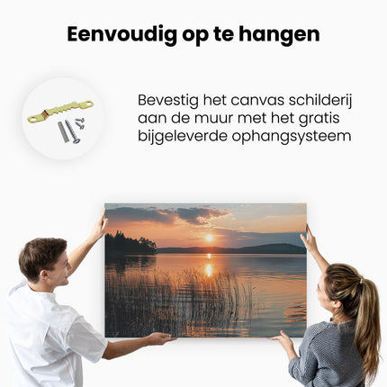 Canvas schilderij ophangen De Zon gaat onder boven een Meer