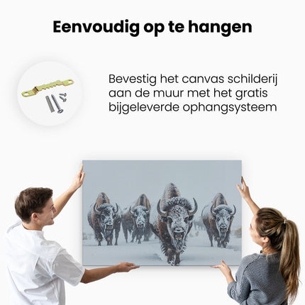 Canvas schilderij ophangen Kudde Bizons die door de Sneeuw loopt