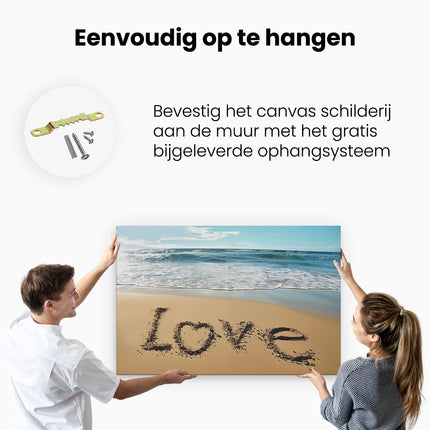 Canvas schilderij ophangen Het Woord Liefde is Geschreven in het Zand op een Strand