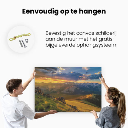 Canvas schilderij ophangen De Zon gaat onder boven een Bergketen