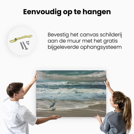 Canvas schilderij ophangen Reiger Staat aan de Oever van de Oceaan