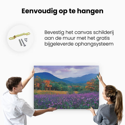 Canvas schilderij ophangen Paarse Bloemen in een Veld met Bergen op de Achtergrond