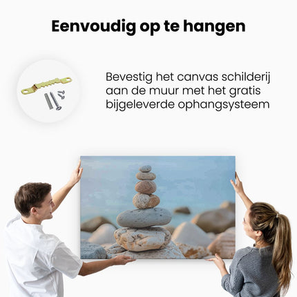 Canvas schilderij ophangen Stapel Stenen op een Strand