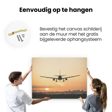 Canvas Schilderij Ophangen Vliegtuig Landt Tijdens Zonsondergang